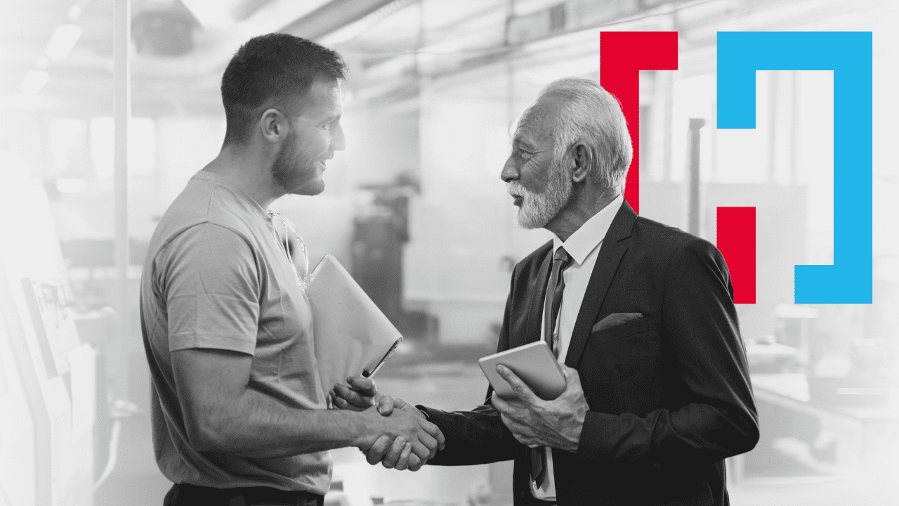 Male recruiter in suit shakes hands with male applicant