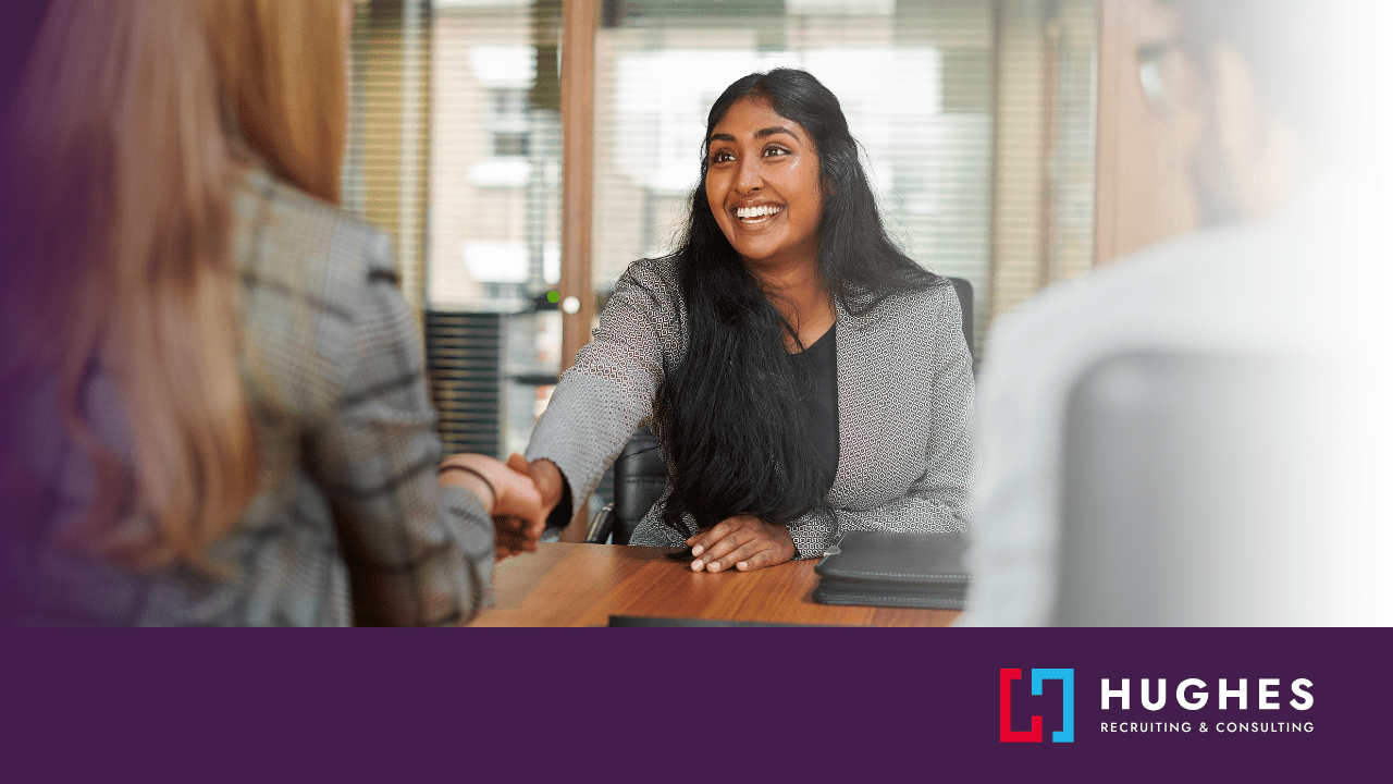 Excited candidate shaking hands with interviewer